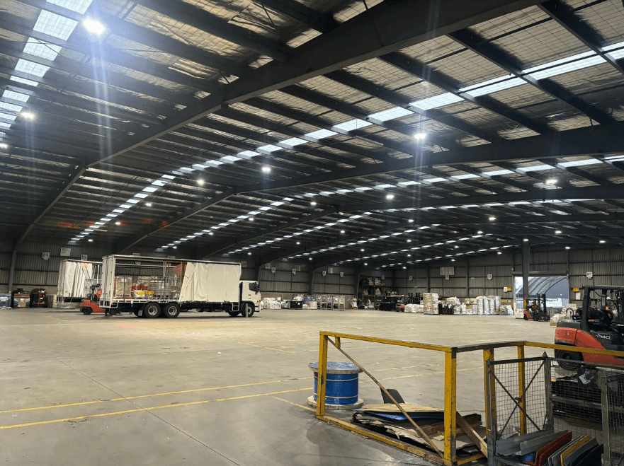 Large commercial warehouse building interior showing professional roofing system